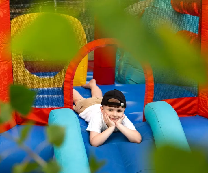 full-shot-smiley-boy-bounce-house