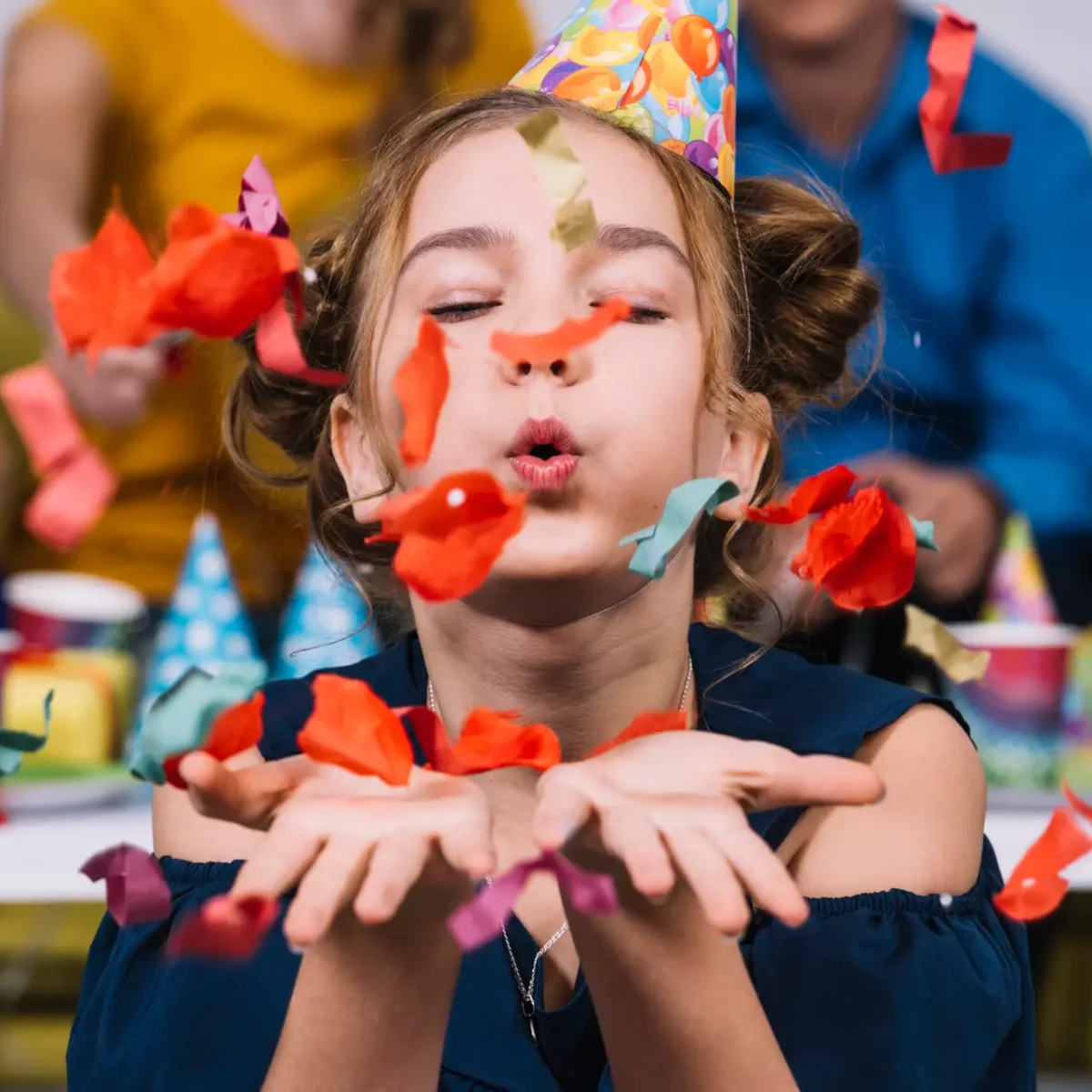 portrait-teenage-girl-blowing-confetti-her-birthday